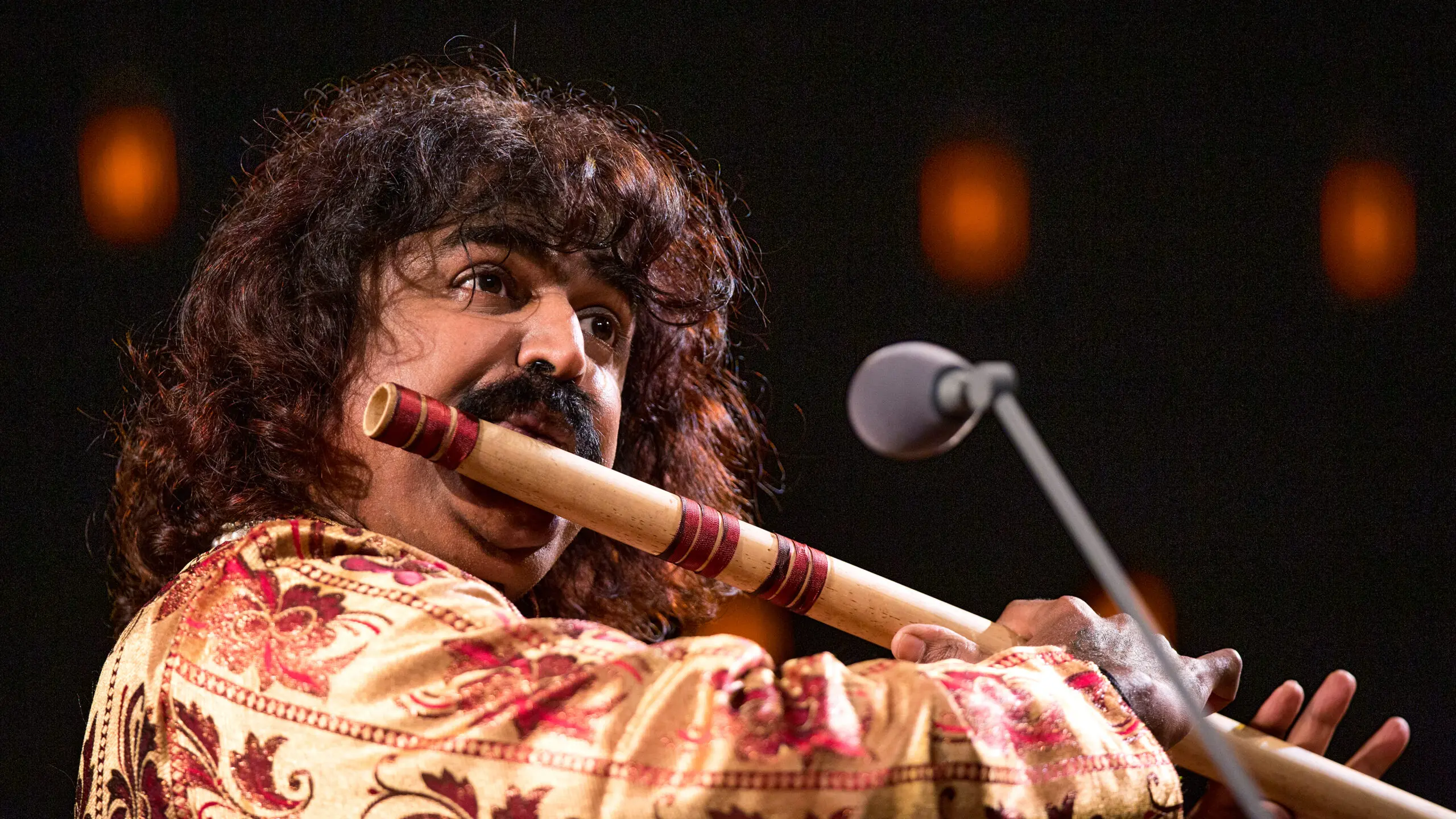 Why do Indian musicians tune their instruments in front of the audience? 